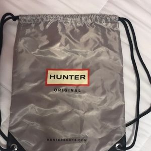 Grey hunter boots carrying bag.